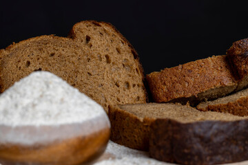 sliced rye bread on a wooden table, close up
