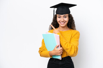 Arab university graduate woman holding books isolated on white background pointing to the side to present a product