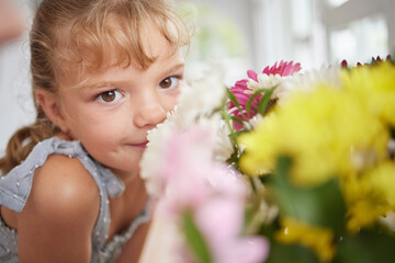 Fototapeta premium Flower smell and little girl in spring portrait with beautiful bouquet of fresh daisies aroma. Young child enjoying sweet and natural scent of bright floral garden petals in family home.