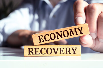 Obraz premium Wooden blocks with words 'Economy Recovery'.