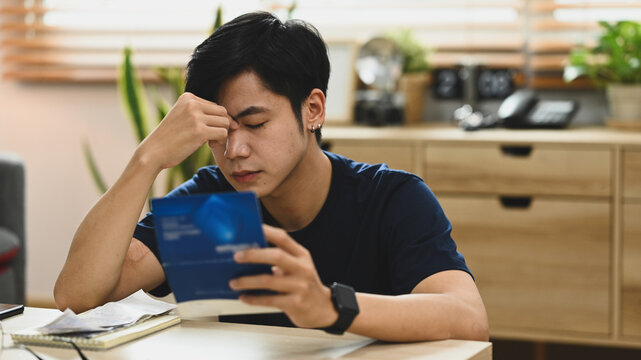 Image of stressed man having financial problem, anxiety about debt and managing expenses finances at home