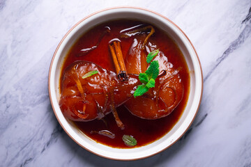 Pears cooked with red wine. Spanish traditional dessert recipe.