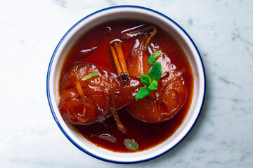 Pears cooked with red wine. Spanish traditional dessert recipe.