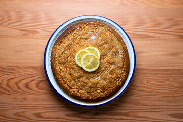 Lemon cake seen from above decorated with a few slices of fruit.
