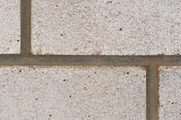 Close-up four white house bricks with vertical and horizontal joint lines creating a geometrical arty pattern