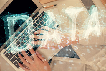 Double exposure of woman hands working on computer and data theme hologram drawing. Top View. Technology concept.