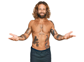 Handsome man with beard and long hair standing shirtless showing tattoos smiling cheerful offering hands giving assistance and acceptance.