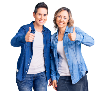 Couple of women wearing casual clothes doing happy thumbs up gesture with hand. approving expression looking at the camera showing success. - Powered by Adobe