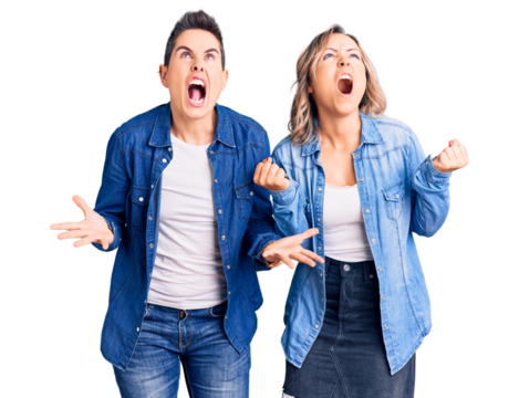 Couple of women wearing casual clothes crazy and mad shouting and yelling with aggressive expression and arms raised. frustration concept.