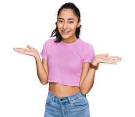 Hispanic teenager girl with dental braces wearing casual clothes smiling showing both hands open palms, presenting and advertising comparison and balance