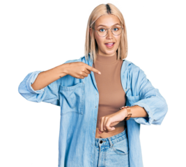 Beautiful young blonde woman wearing glasses in hurry pointing to watch time, impatience, upset and angry for deadline delay