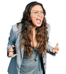 Young hispanic girl wearing business clothes and glasses crazy and mad shouting and yelling with...