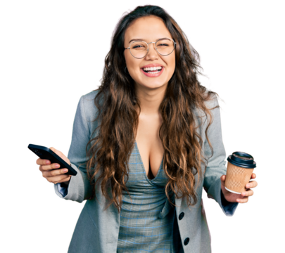 Young hispanic girl using smartphone and drinking a cup of coffee smiling and laughing hard out loud because funny crazy joke.