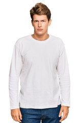 Fototapeta premium Handsome caucasian man wearing casual white sweater relaxed with serious expression on face. simple and natural looking at the camera.