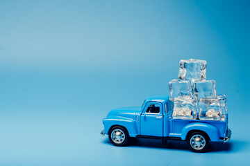 Fototapeta na wymiar Toy car with ice. Ice delivery. Ice cubes