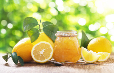Glass jar of lemon jam and fresh fruits