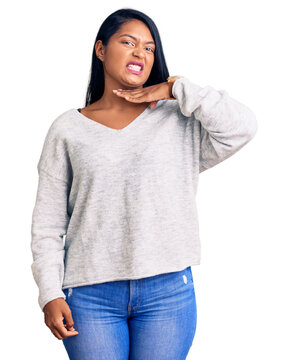 Hispanic woman with long hair wearing casual clothes cutting throat with hand as knife, threaten aggression with furious violence