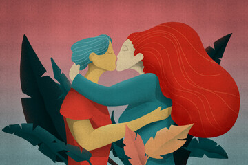 Kiss of love between a woman with red hair and a man in the middle of the leaves of nature