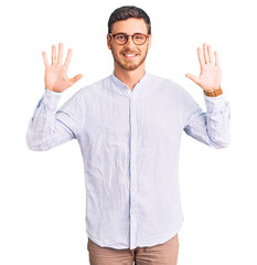 Handsome young man with bear wearing elegant business shirt and glasses showing and pointing up with fingers number ten while smiling confident and happy.