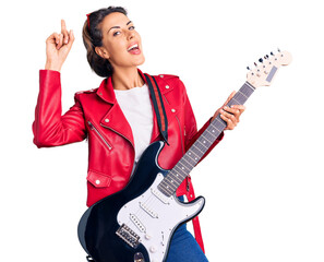Young beautiful woman playing electric guitar surprised with an idea or question pointing finger...