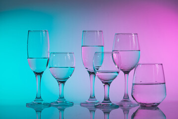 Wine glasses with neon multicolor light