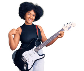 Young african american girl playing electric guitar pointing finger to one self smiling happy and...