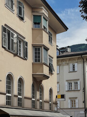 Old ancient historical architecture in Italia. Traditional European buildings with wooden windows, shutters, pastel walls. Summer holidays vacation traveling concept