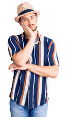 Young handsome caucasian man wearing summer hat thinking looking tired and bored with depression problems with crossed arms.