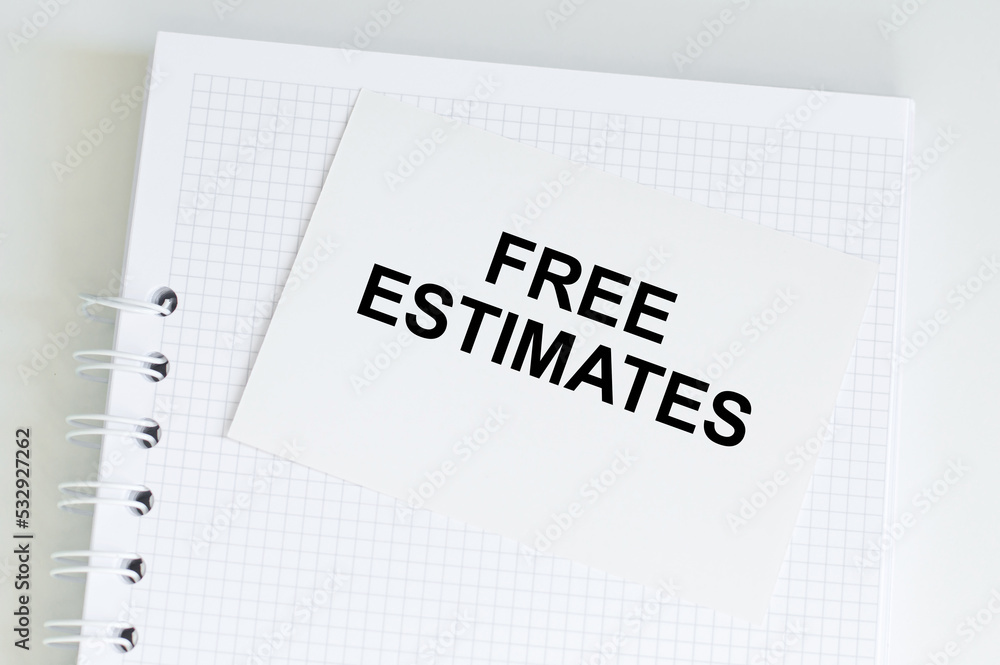 Poster a white card with the text free estimates on the background of an open paper notebook and a metal pe