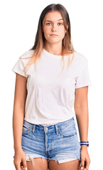 Obraz premium Beautiful caucasian woman wearing casual white tshirt looking sleepy and tired, exhausted for fatigue and hangover, lazy eyes in the morning.