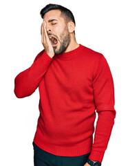 Young hispanic man wearing casual clothes yawning tired covering half face, eye and mouth with...