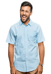 Obraz premium Handsome hispanic man wearing casual clothes winking looking at the camera with sexy expression, cheerful and happy face.