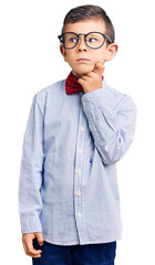Cute blond kid wearing nerd bow tie and glasses serious face thinking about question with hand on...