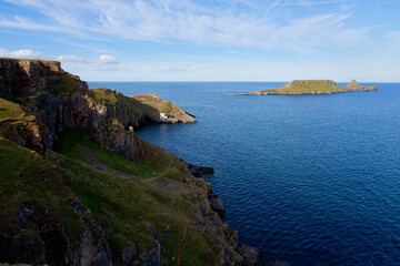 Fototapeta premium From the rugged cliffs of Rhossili to Worms Head island