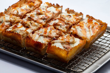 detroit pizza on an iron tray