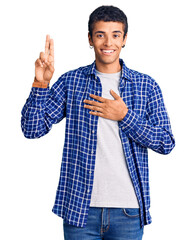 Young african amercian man wearing casual clothes smiling swearing with hand on chest and fingers up, making a loyalty promise oath