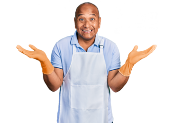 Hispanic middle age man wearing cleaner apron and gloves celebrating victory with happy smile and winner expression with raised hands