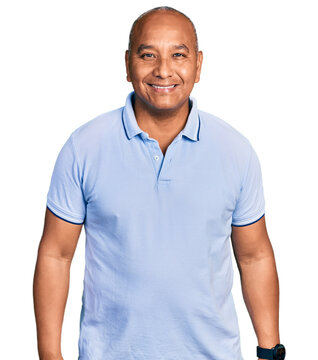 Hispanic middle age man wearing casual t shirt with a happy and cool smile on face. lucky person.