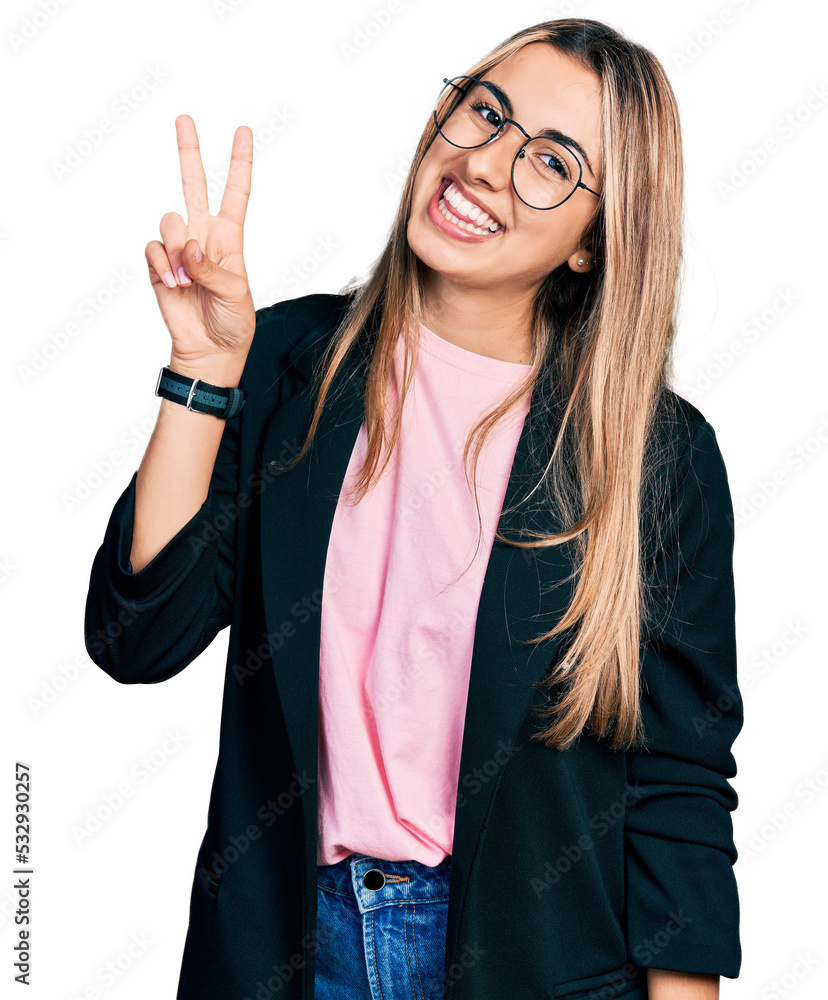 Wall mural hispanic young woman wearing business jacket and glasses showing and pointing up with fingers number