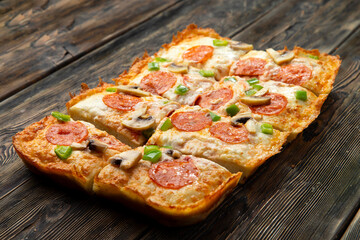 detroit pizza on a wooden table.