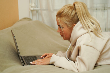 Blonde woman working on laptop