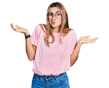 Hispanic young woman wearing casual t shirt and glasses clueless and confused expression with arms and hands raised. doubt concept.