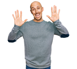 Bald man with beard wearing casual clothes showing and pointing up with fingers number ten while smiling confident and happy.