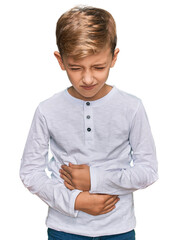 Little caucasian boy kid wearing casual clothes with hand on stomach because indigestion, painful...