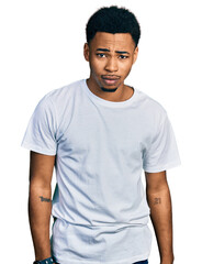 Young african american man wearing casual white t shirt depressed and worry for distress, crying angry and afraid. sad expression.