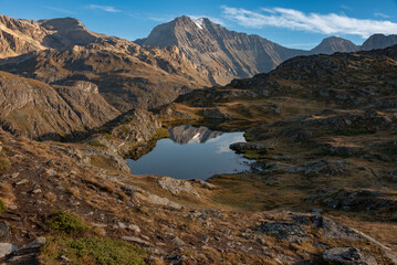 Fototapeta na wymiar In the early morning and in good weather, the arrival on the Bellecombe lake in the heart of the Vanoise national park in the Alps is a wonderful moment