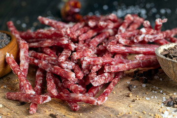 thin dried meat sausages with spices , close up