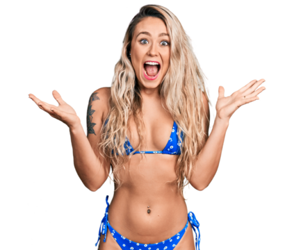 Young blonde woman wearing bikini celebrating crazy and amazed for success with arms raised and open eyes screaming excited. winner concept - Powered by Adobe