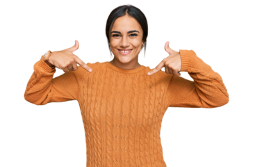 Young brunette woman wearing casual winter sweater looking confident with smile on face, pointing oneself with fingers proud and happy.