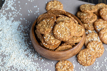oatmeal thin round cookies with lots of sesame seeds